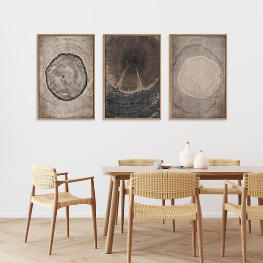Dining room with wooden table and chairs, and three framed tree ring artworks on the wall.