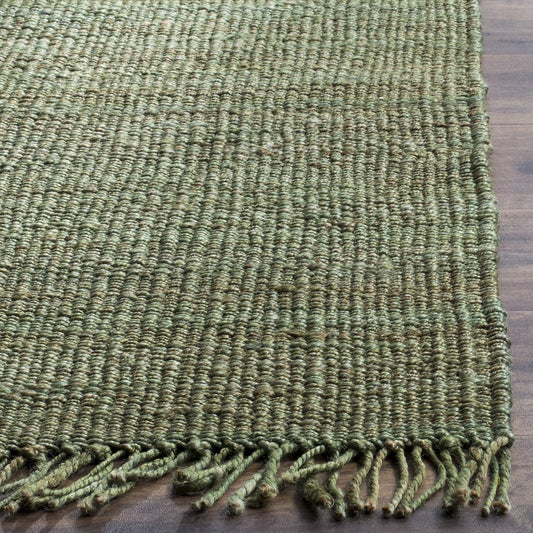 Green textured rug with tassels on a wooden floor