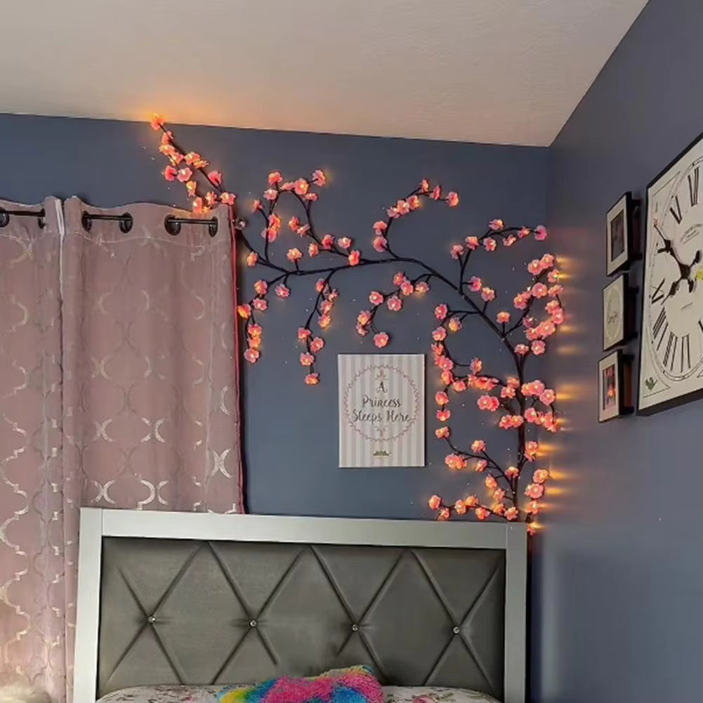cherry blossom branch shaped led with warm glowing light over a bed in kids room decor