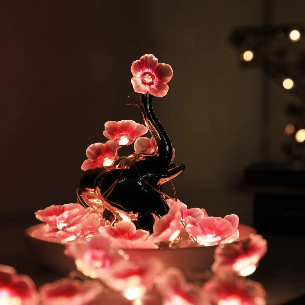 Cherry Blossom Branch Shaped LED Lights showing a beautiful pin warm glow on a elephant sculpture