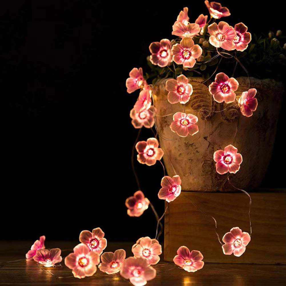 Cherry Blossom Branch Shaped LED Lights on a planter and a close up view in dark