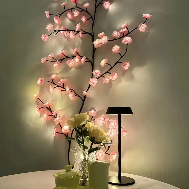 Cherry Blossom Branch Shaped LED Lights on a wall corner with a table and lamp