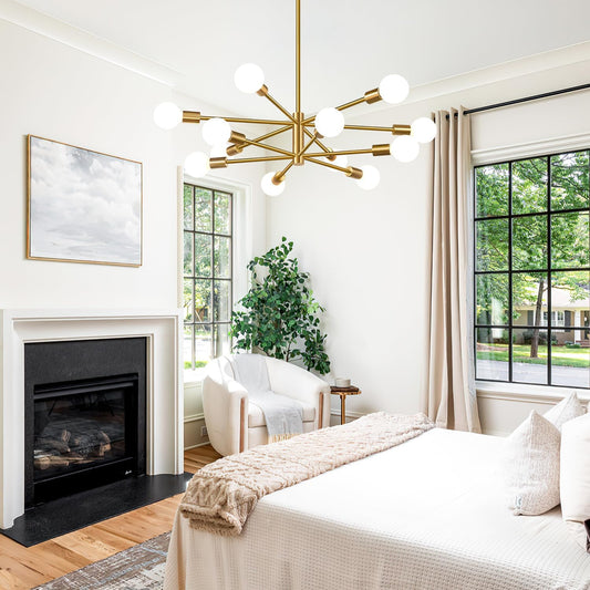 Modern bedroom with a gold chandelier, fireplace, and large windows.