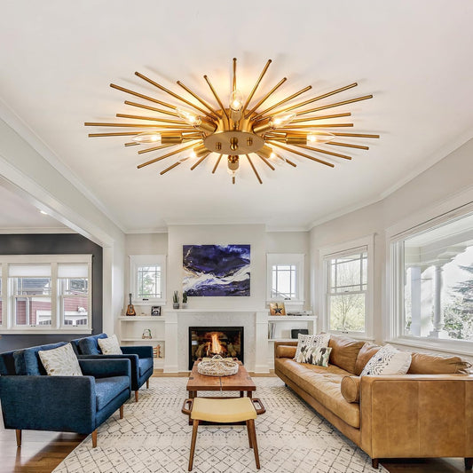 Living room with a gold ceiling light fixture, brown sofa, blue armchair, and fireplace.