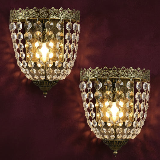 Two ornate wall sconces with crystal details on a light background.