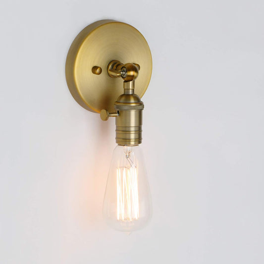 Brass wall sconce with a lit bulb on a white background