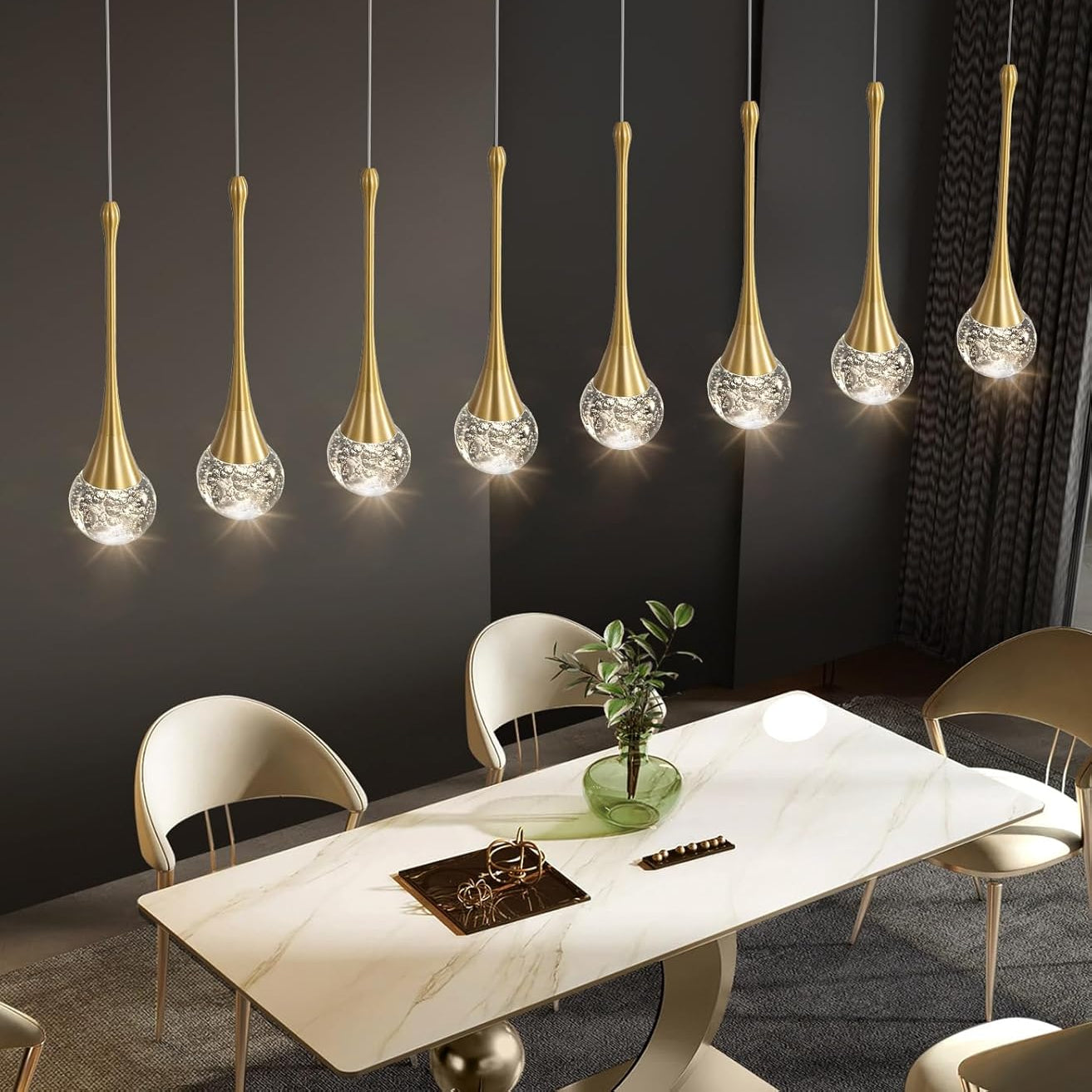 Modern dining room with gold pendant lights and a marble table.