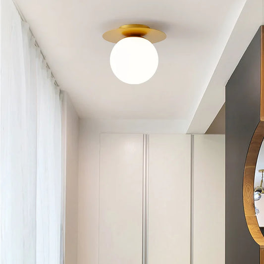 Stylish white and gold light fixture mounted on a ceiling, featuring the Luminova White Glow Ceiling Lamp.