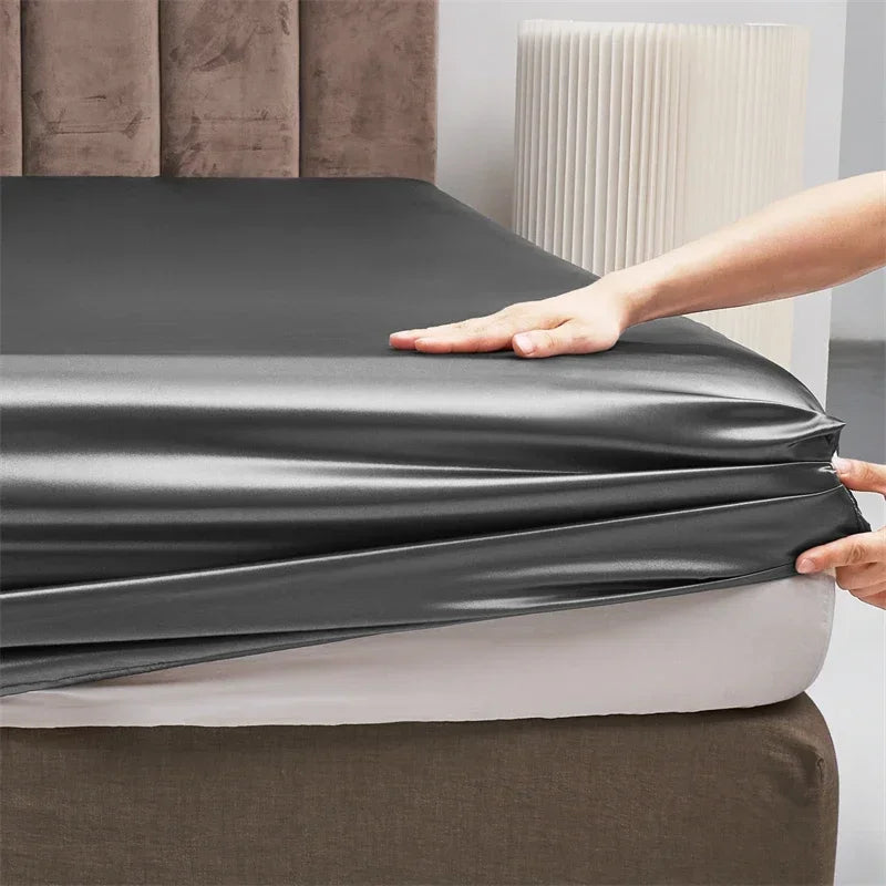 Enhance your bedroom with the Opulent Satin Bed Sheet Set, as seen on this bed with a gray satin sheet.