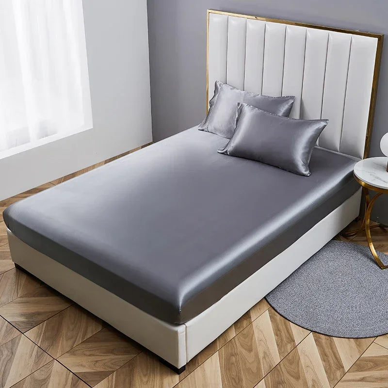 The Opulent Satin Bed Sheet Set adds a touch of luxury to this bed, with its gray satin sheet exuding elegance.