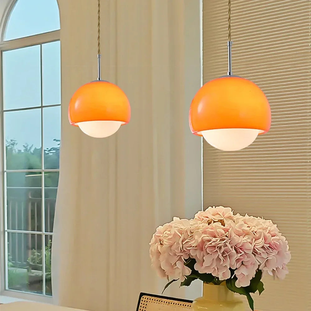 Two orange Crystal Glow Pendant Lamp lights hanging from the ceiling.