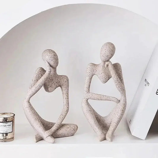 The Thinker Statue: A tabletop art piece depicting a contemplative figure in a seated position, deep in thought.