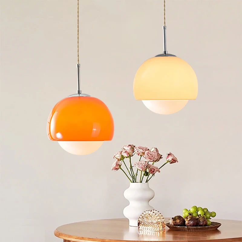 An elegant table setting with a vase of flowers and a Crystal Glow Pendant Lamps.