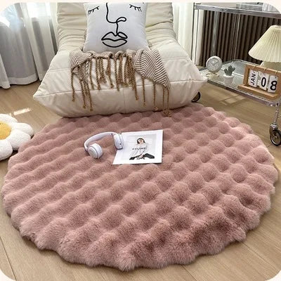 Luxurious round rug with light red fur, evoking the look of a snowy soft faux rabbit rug.