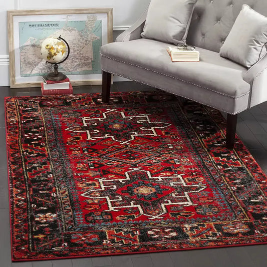 Traditional red Persian rug with central floral medallion and ornate border on hardwood floor in living room