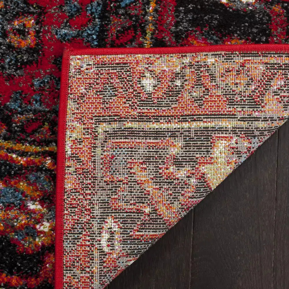 Detail shot of red Persian rug corner showcasing symmetrical geometric patterns and detailed border design