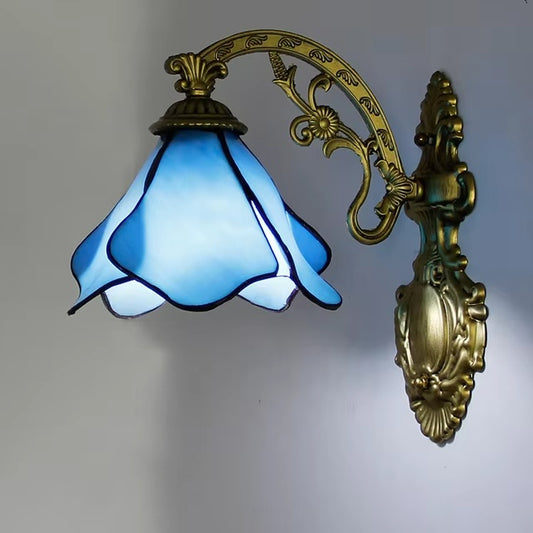 A vintage stained glass wall lamp with a blue color and bronze mounting, featuring a classic Tiffany lamp design.