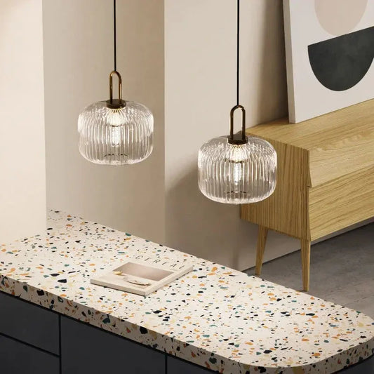 Two Vintage Glass Pendant Lights with a clear and colorful glass design, hanging over a kitchen counter, with no visible power source.