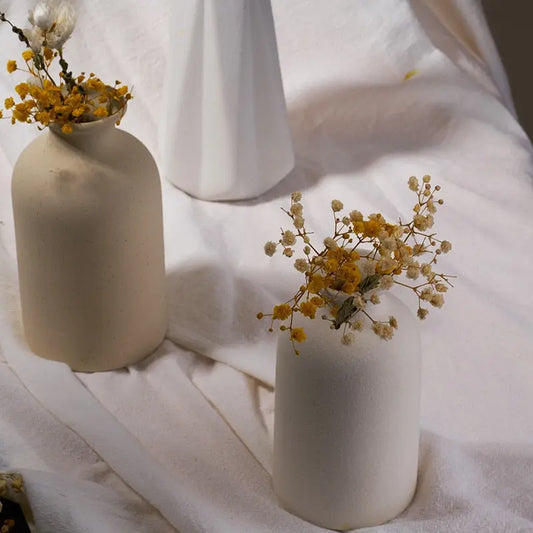 cream white and clay flower vases