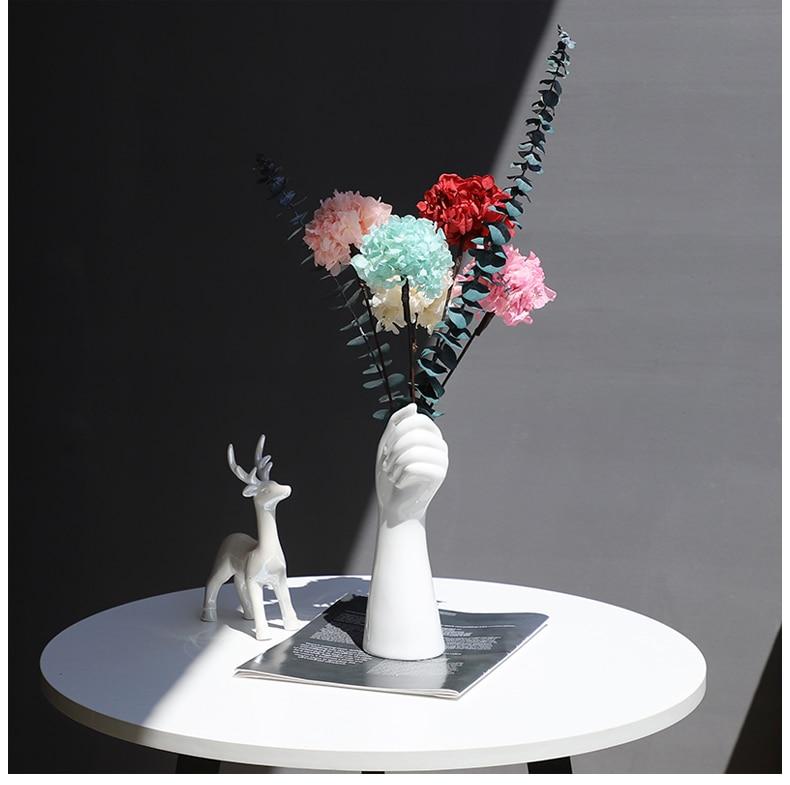 white sculpture vases