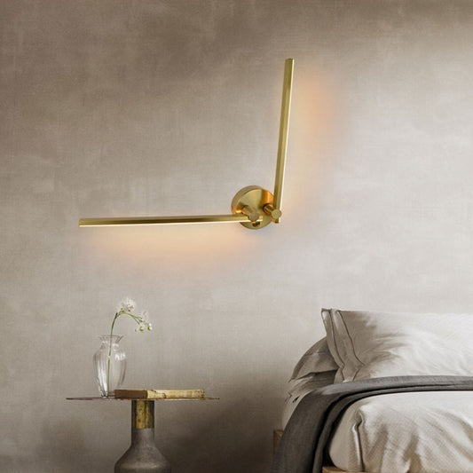 modern bedroom wall sconce with warm light on bedside walls