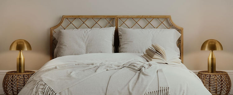 two table lamps are placed on a side tables of bed in bedroom