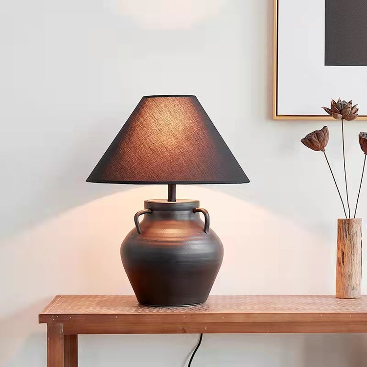 dark grey clay table lamp on a wooden table in living room