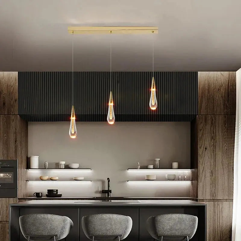 teardrop gold chandeliers over kitchen island