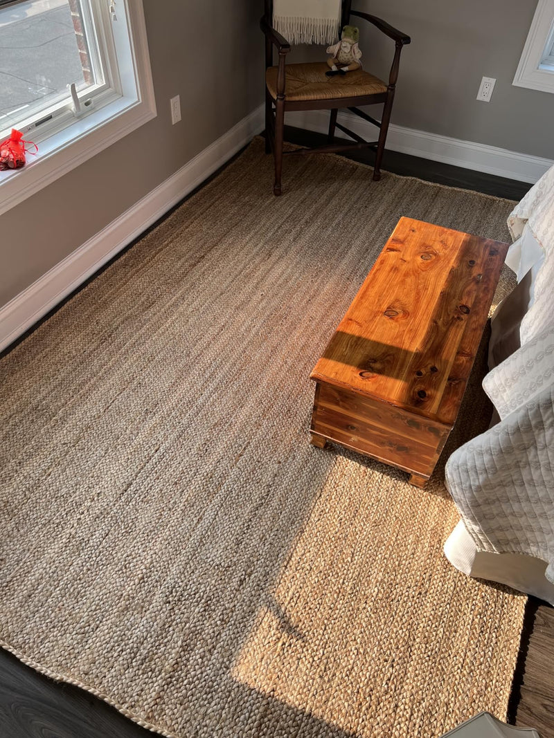 handwoven jute rug placed under bed in bedroom