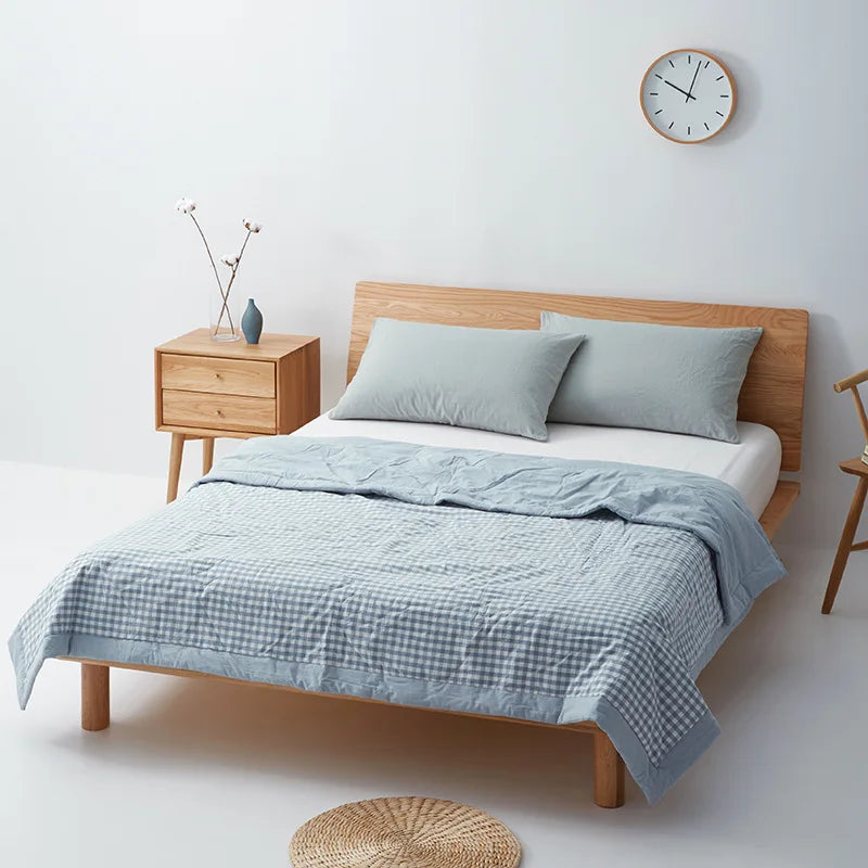 summer bedroom decor with our cool bed comforter on a wooden bed in a light minimalist decor