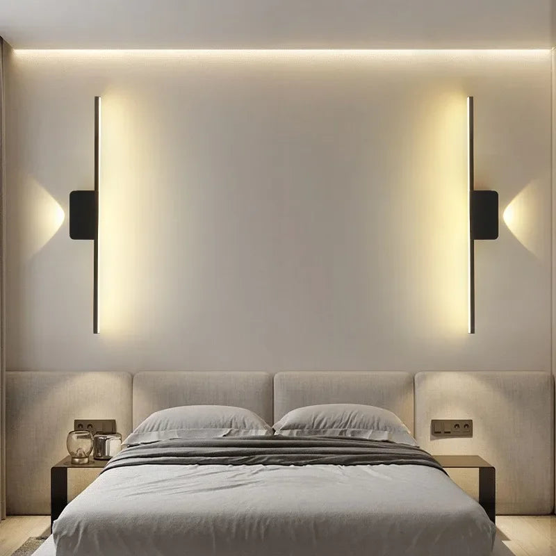 minimalist wall sconces on both bedsides glowing warm light