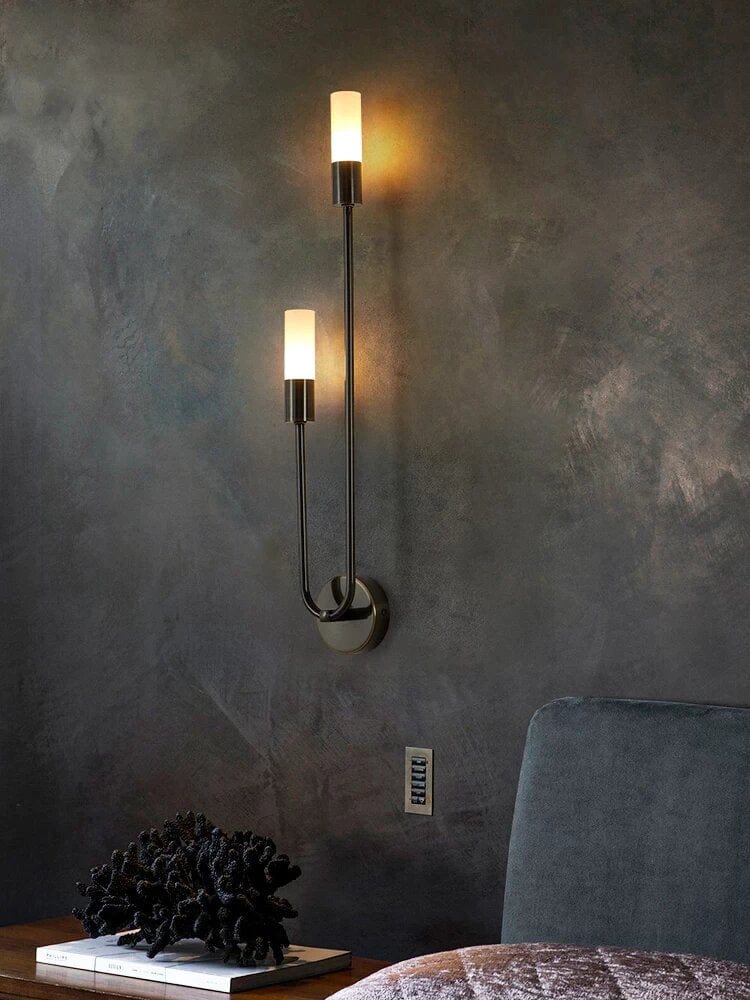 black u shape wall sconce on bedside on dark wall 