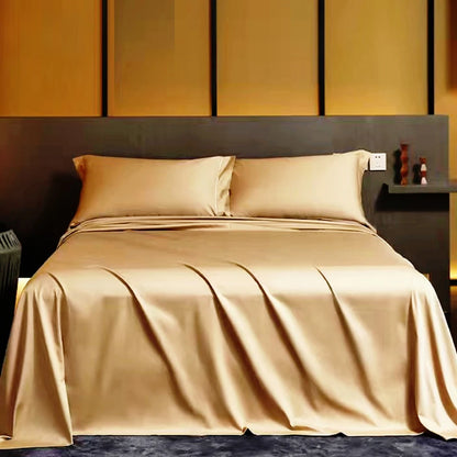 A luxurious bed adorned with a gold-colored sheet and pillow from the LuxeSatin Summer Bed Sheet Set.