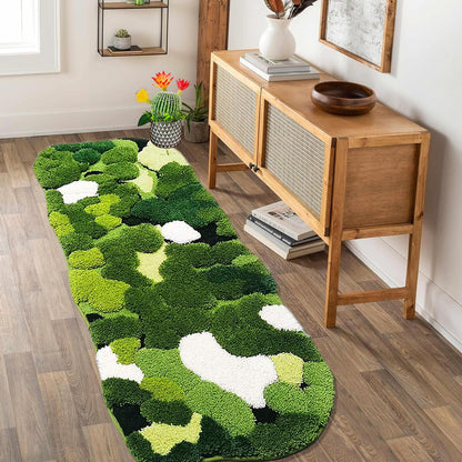 Green and white patterned rug on a wooden floor with a wooden console table in the background.