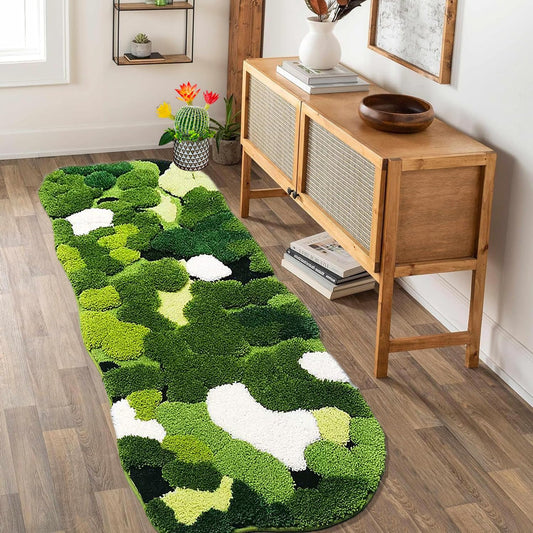 Green and white patterned rug on a wooden floor with a wooden console table in the background.