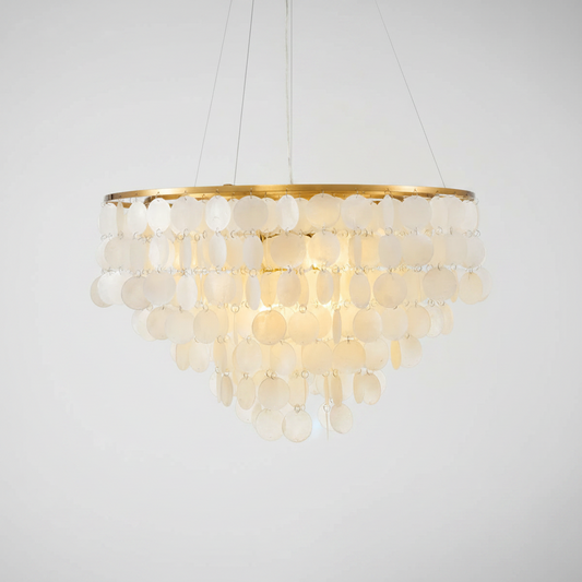 A modern circular chandelier with a gold-finished top rim and multiple tiers of frosted, disc-like glass shades that glow warm white when illuminated, suspended against a plain light gray background.