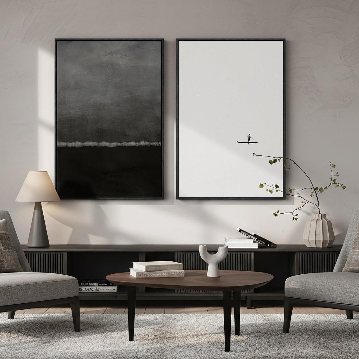 Modern living room with two framed artworks on the wall, a coffee table, and gray chairs.