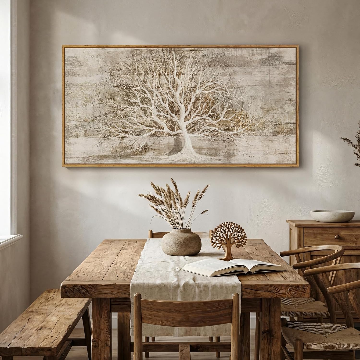 Dining room with wooden table, chairs, and a large framed tree artwork on the wall.