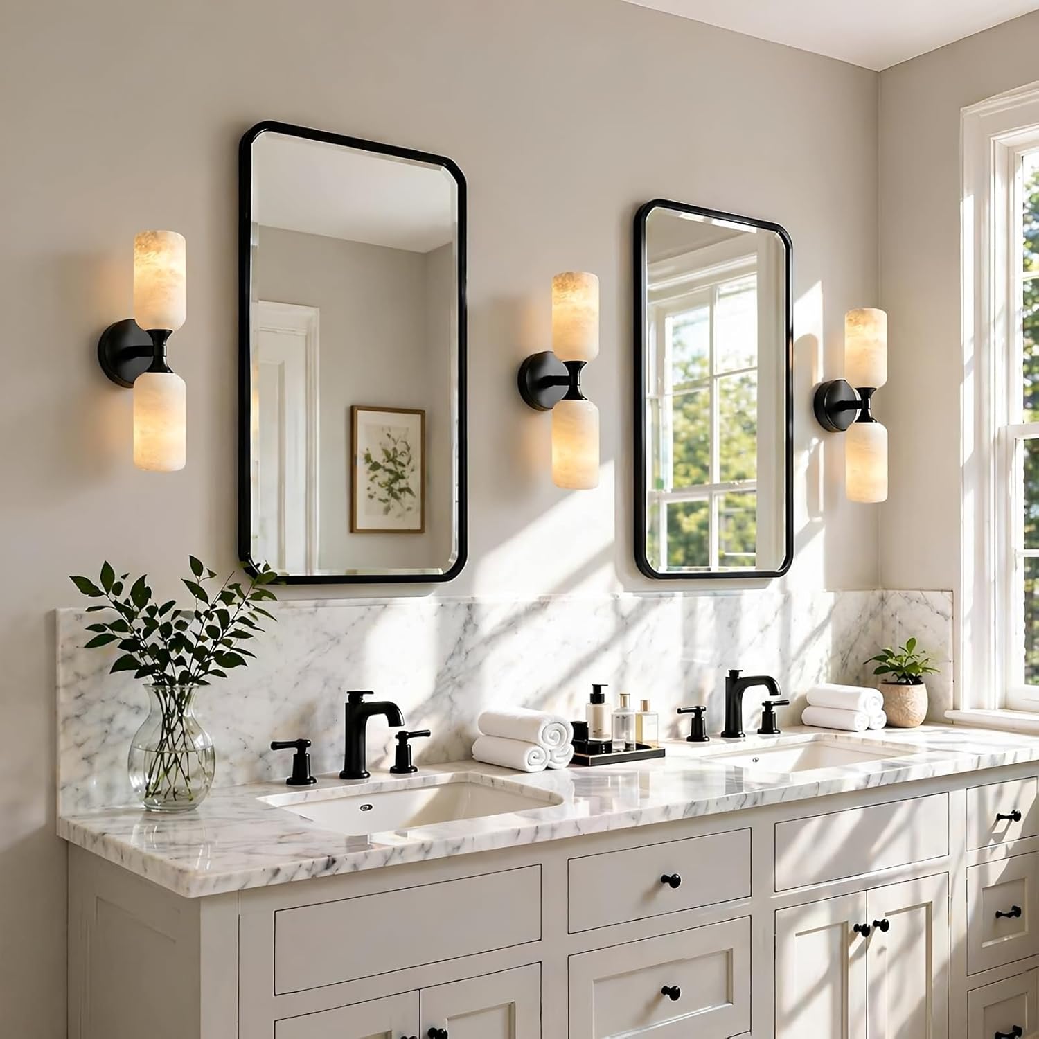 Bathroom vanity with marble countertop, mirrors, and lighting fixtures.