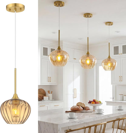 Gold pendant lights with glass shades in a kitchen setting