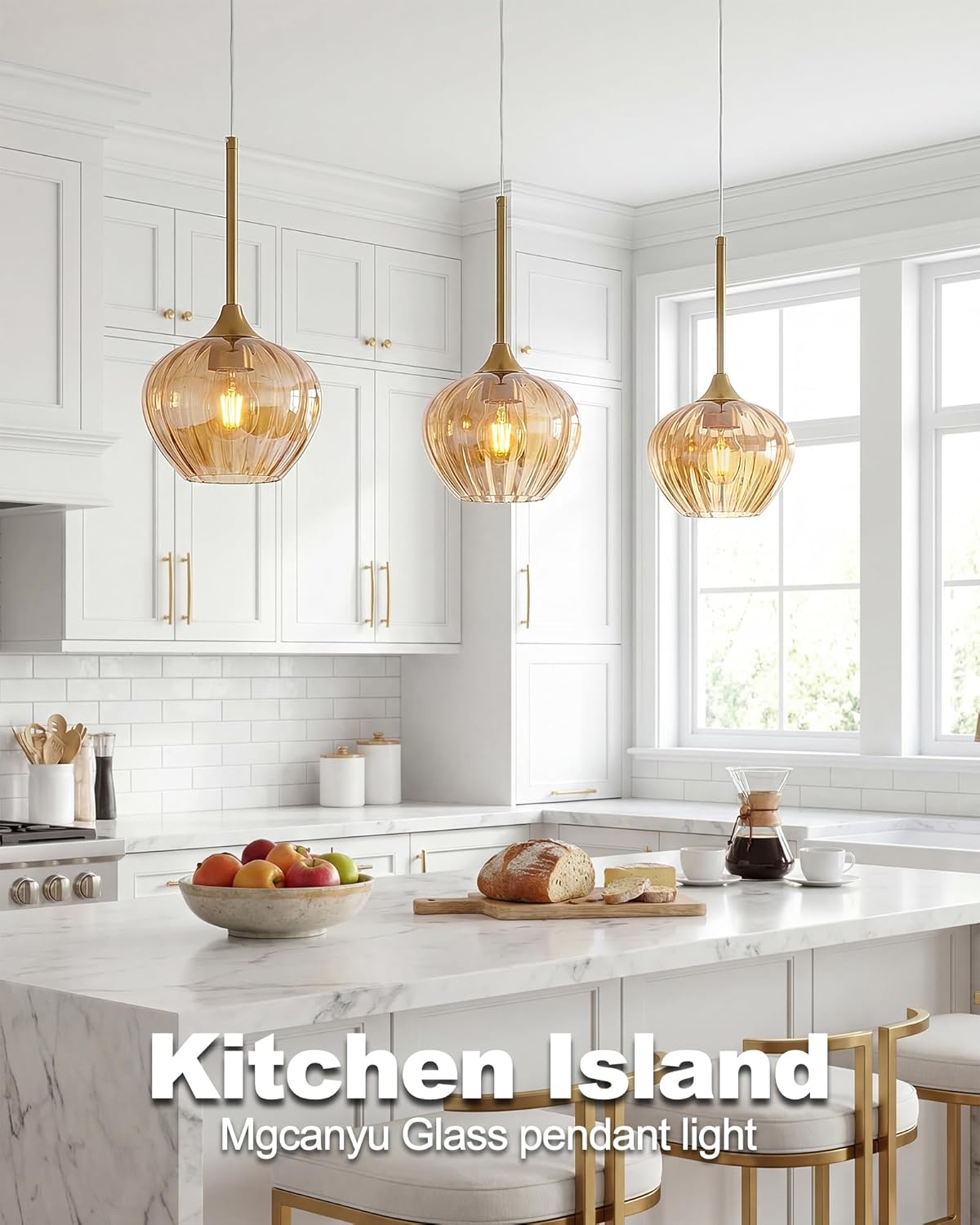 Modern kitchen with marble island, glass pendant lights, and white cabinets.