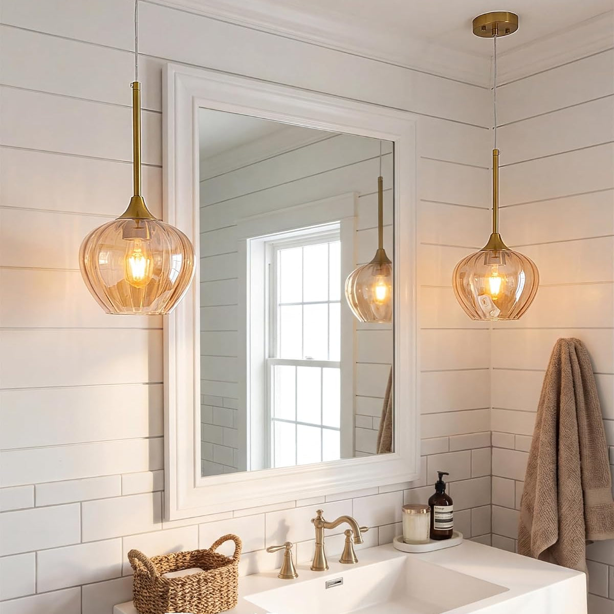Bathroom with a sink, mirror, and glass pendant lights.