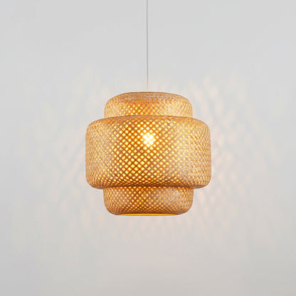 Woven pendant light with a warm glow against a neutral background