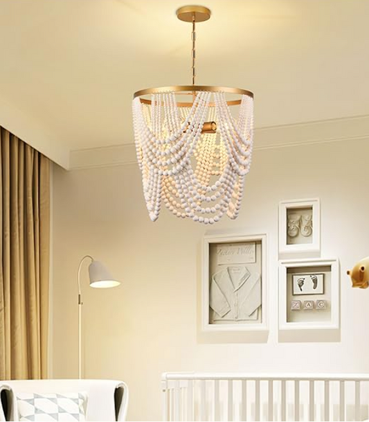 Beaded chandelier hanging in a room with light-colored walls and decor.