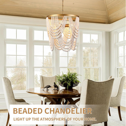 Beaded chandelier hanging above a dining table in a bright room with large windows.