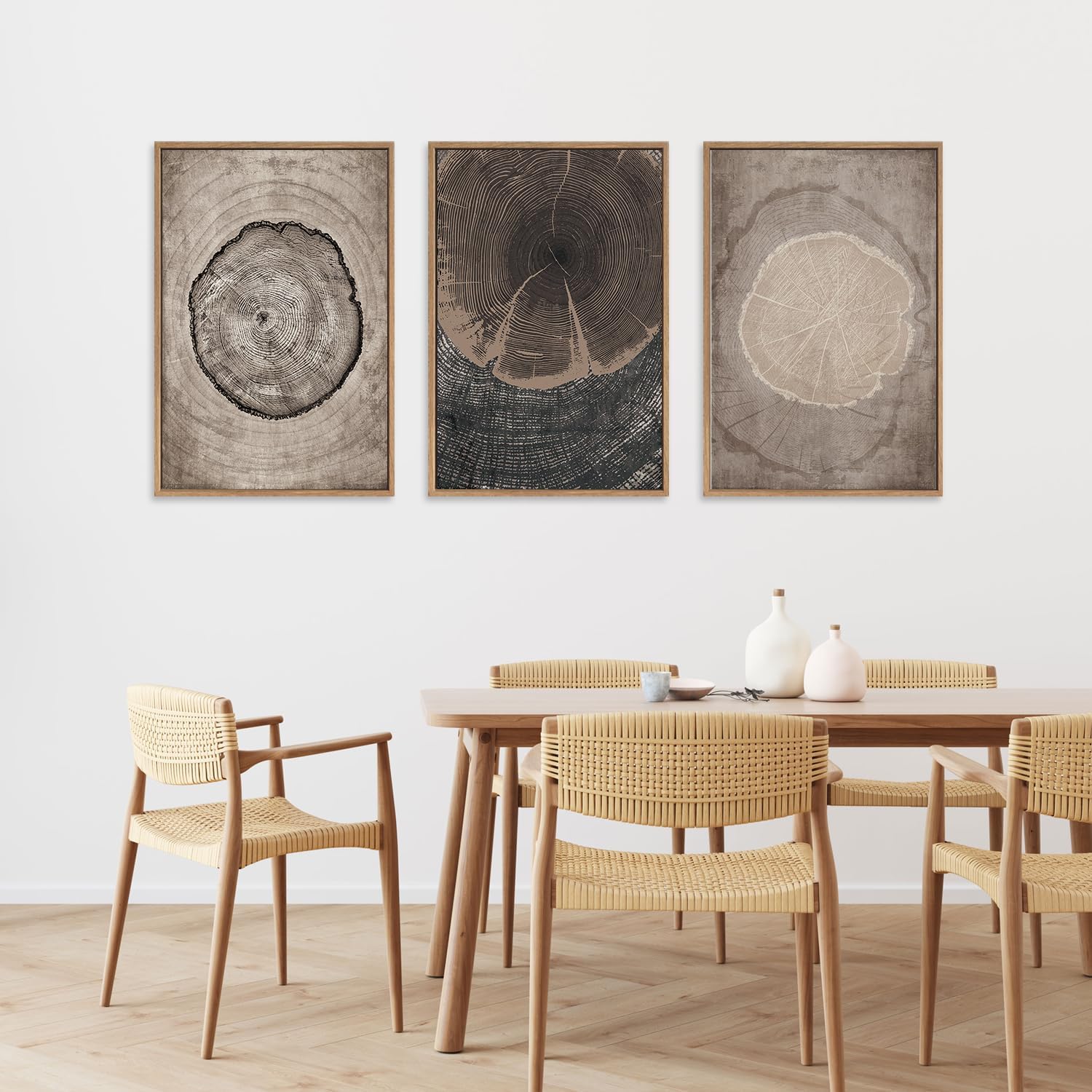 Dining room with wooden table and chairs, and three framed tree ring artworks on the wall.