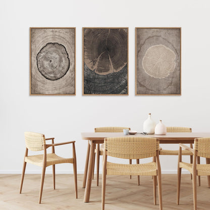 Dining room with wooden table and chairs, and three framed tree ring artworks on the wall.