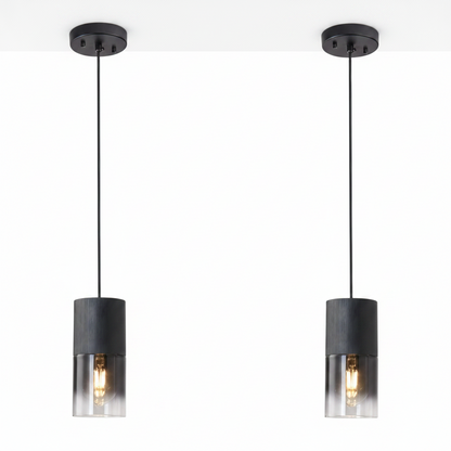 Two black pendant lights with clear glass shades on a white background
