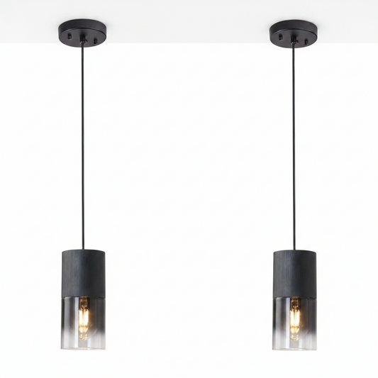 Two black pendant lights with clear glass shades on a white background