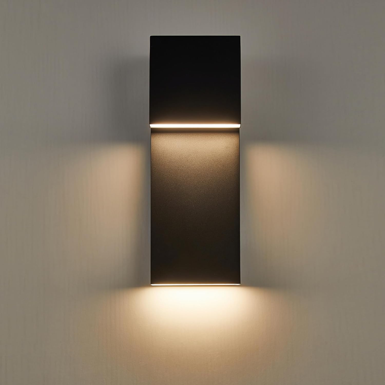 Modern wall-mounted light fixture on a gray wall